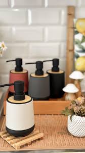 round black base home and fun soap dispenser with wood edge